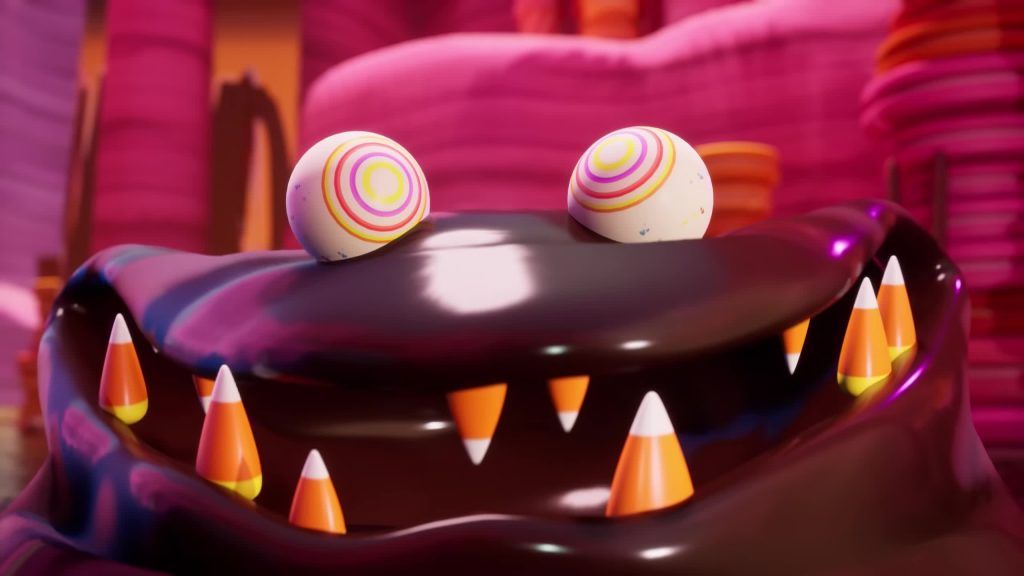 Close-up of The Fudge monster smiling with candy corn teeth and lollipop eyes.