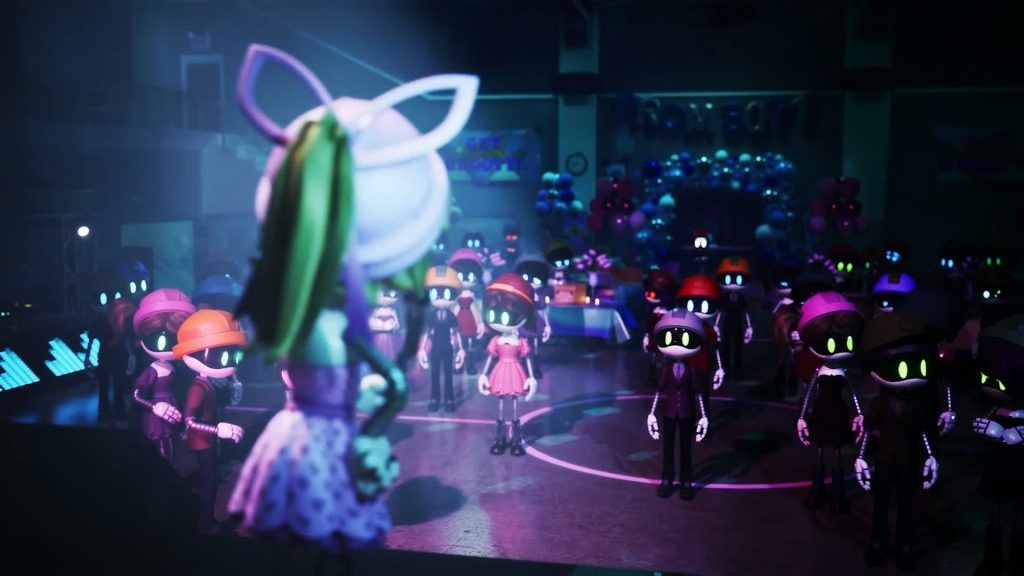 Lizzy standing on a stage in front of a crowd of drones during a decorated school dance
